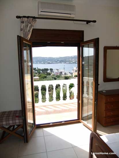 looking through French doors in bedroom across Alinda bay